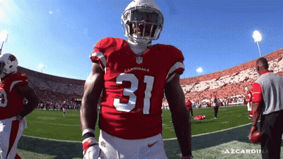 A Cardinals Football Player Stands On The Field GIF