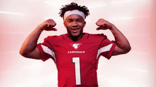 A Cardinals Player Flexes His Muscles In A Red Jersey GIF