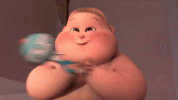 A Cartoon Baby Is Holding A Rattle And Smiling While Sitting On A Bed . GIF