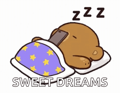 A Cartoon Bear Is Sleeping In A Bed With A Cell Phone In Its Paws . GIF