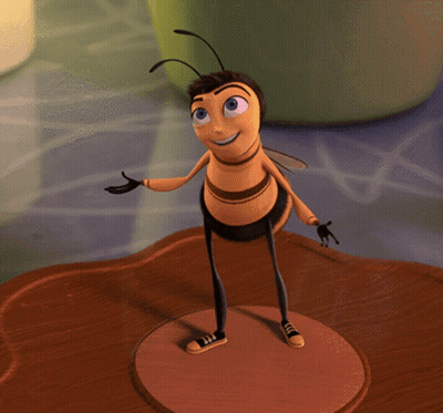 A Cartoon Bee Is Standing On A Brown Surface And Smiling GIF