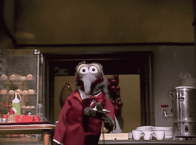 A Cartoon Bird Is Standing In Front Of A Display Of Eggs GIF