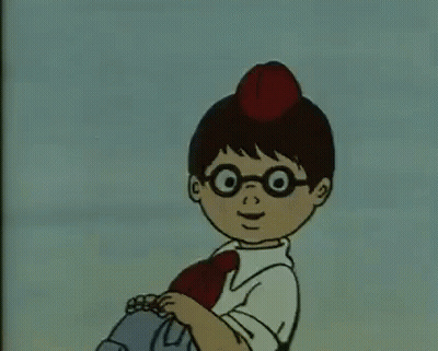 A Cartoon Boy With Glasses Is Sitting On A White Winged Object . GIF