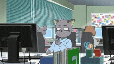 A Cartoon Cat Is Sitting At A Desk With A Cell Phone In His Hand GIF