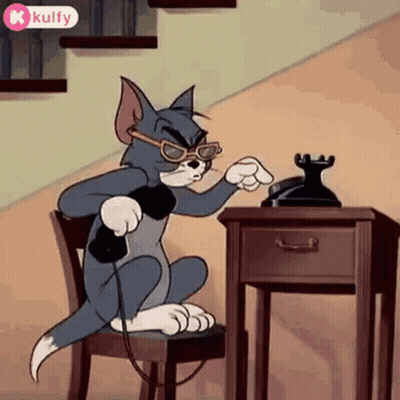 A Cartoon Cat Is Sitting In A Chair Talking On A Phone . GIF