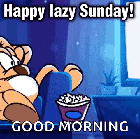 A Cartoon Cat Is Sitting On A Couch Eating Popcorn And Says Happy Lazy Sunday ! Good Morning . GIF