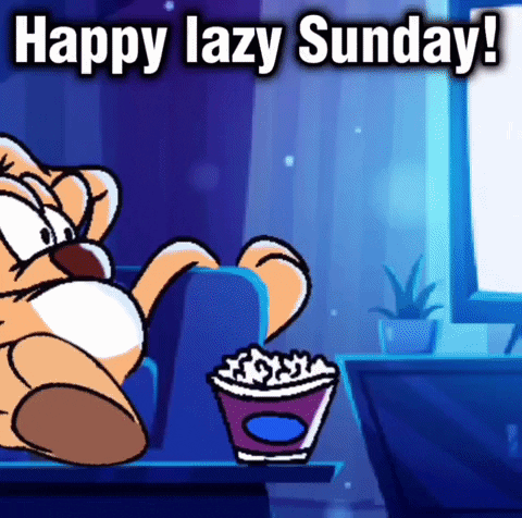 A Cartoon Cat Is Sitting On A Couch With A Cup Of Popcorn . GIF
