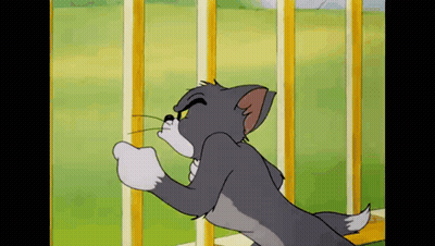 A Cartoon Cat Is Standing Next To A Fence And Looking At Something . GIF