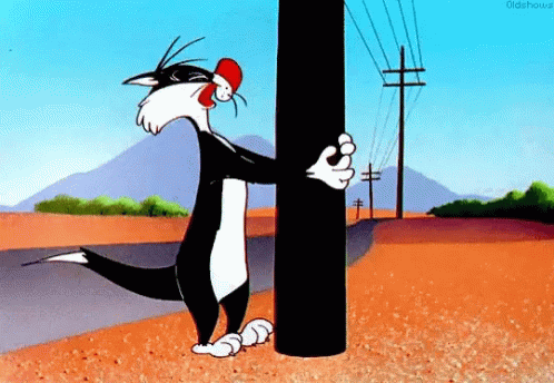 A Cartoon Cat Is Standing Next To A Power Pole . GIF