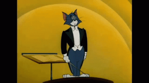 A Cartoon Cat Is Wearing A Tuxedo And Holding A Conductor 'S Baton . GIF