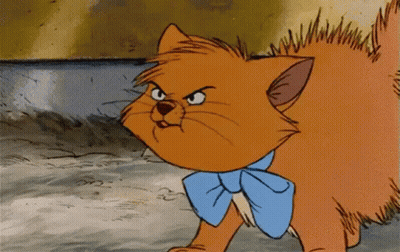 A Cartoon Cat Wearing A Blue Bow Tie Is Looking Angry GIF