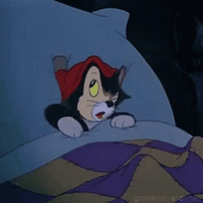 A Cartoon Cat Wearing A Red Hat Is Laying In Bed GIF