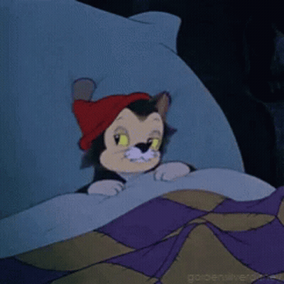 A Cartoon Cat Wearing A Red Hat Is Laying On A Bed GIF