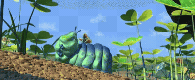A Cartoon Caterpillar Is Crawling Through A Field Of Plants GIF