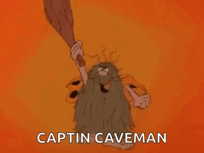 A Cartoon Caveman With A Beard Is Holding A Bat And Saying `` Captin Caveman '' . GIF