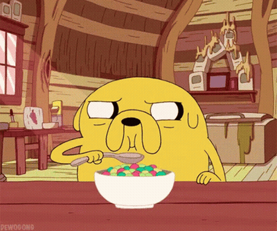 A Cartoon Character From Adventure Time Is Eating A Bowl Of Cereal With A Spoon GIF