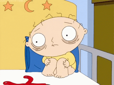 A Cartoon Character From Family Guy Is Sitting In A Bed With A Red Object . GIF