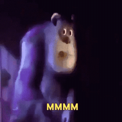 A Cartoon Character From Monsters Inc Is Standing In A Dark Room With The Word Mmmm Written On The Bottom . GIF