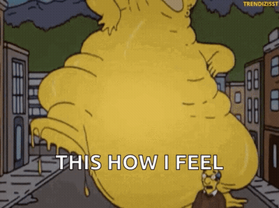 A Cartoon Character From The Simpsons Is Standing Next To A Giant Yellow Monster . GIF
