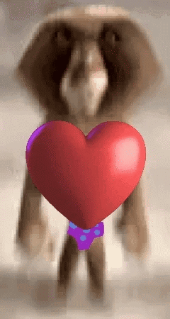 A Cartoon Character Holding A Red Heart In His Hands GIF