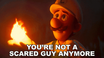 A Cartoon Character Holding A Torch With The Words " You 'Re Not A Scared Guy Anymore " Above Him GIF