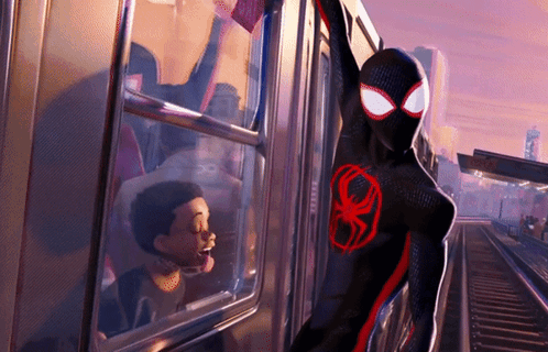 A Cartoon Character In A Black And Red Suit With A Red Spider On His Chest Is Standing Next To A Train GIF