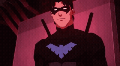 A Cartoon Character In A Black Suit With A Blue Bird On His Chest GIF