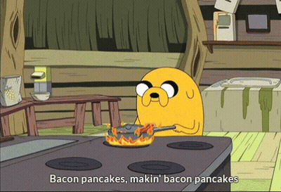 A Cartoon Character Is Cooking Bacon Pancakes On The Stove GIF