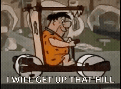 A Cartoon Character Is Driving A Car With The Words `` I Will Get Up That Hill '' Written On It . GIF