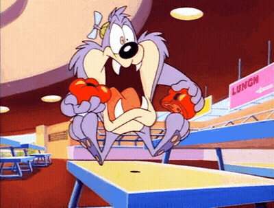 A Cartoon Character Is Eating A Tomato In Front Of A Lunch Sign GIF