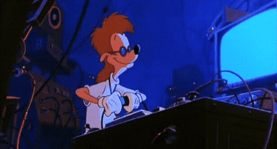 A Cartoon Character Is Giving A Thumbs Up While Sitting At A Desk GIF