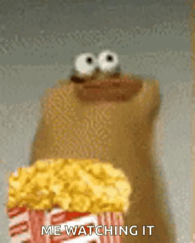 A Cartoon Character Is Holding A Bag Of Popcorn . GIF