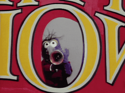 A Cartoon Character Is Holding A Megaphone In Front Of A Sign That Says Love GIF