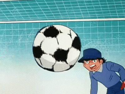 A Cartoon Character Is Kicking A Soccer Ball In A Goal . GIF