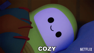 A Cartoon Character Is Laying Down With The Word Cozy Below It GIF