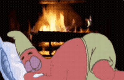 A Cartoon Character Is Laying In Front Of A Fire GIF