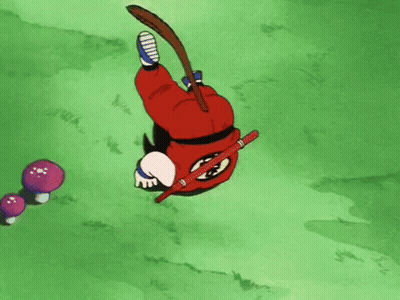 a cartoon character is laying on his back in the grass with a stick in his hand .
