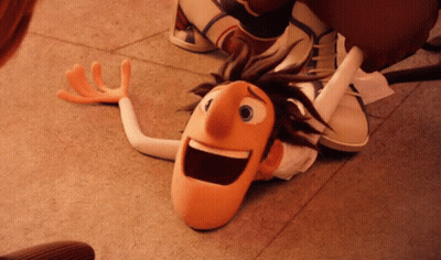 A Cartoon Character Is Laying On The Floor With His Mouth Open And Arms Outstretched . GIF