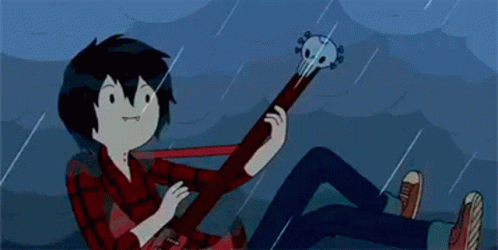A Cartoon Character Is Laying On The Ground Playing A Guitar . GIF