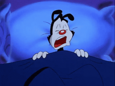 A Cartoon Character Is Laying Under A Blue Blanket GIF