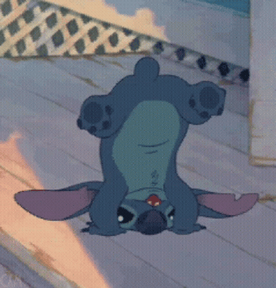 A Cartoon Character Is Laying Upside Down On A Wooden Floor GIF