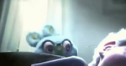 A Cartoon Character Is Looking At A Person 'S Face In A Mirror . GIF