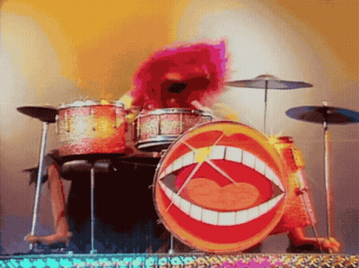 A Cartoon Character Is Playing Drums With A Big Mouth On It GIF