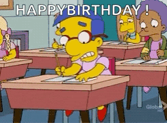 A Cartoon Character Is Sitting At A Desk In A Classroom And Says " Happy Birthday " GIF