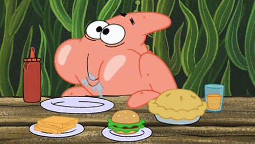A Cartoon Character Is Sitting At A Table Eating Food GIF