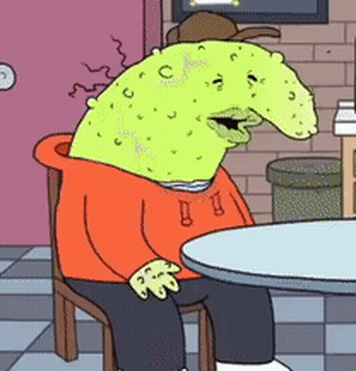 A Cartoon Character Is Sitting At A Table Wearing An Orange Hoodie And Hat GIF