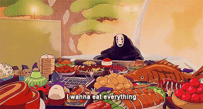 A Cartoon Character Is Sitting At A Table With A Lot Of Food . GIF