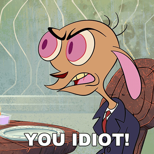 A Cartoon Character Is Sitting At A Table With A Plate And The Words You Idiot GIF