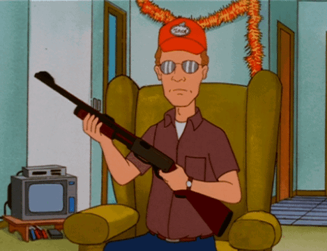 A Cartoon Character Is Sitting In A Chair Holding A Rifle GIF