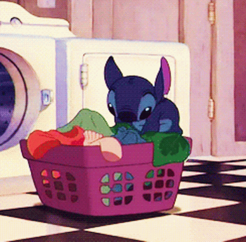 A Cartoon Character Is Sitting In A Purple Laundry Basket GIF